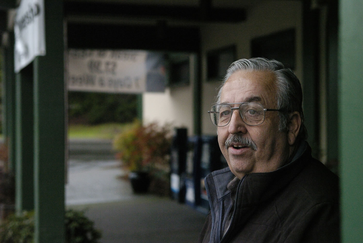 Woodland City Councilor John J. Burke stands at the front entrance of the Oak Tree Casino Restaurant, which shut down in December.
