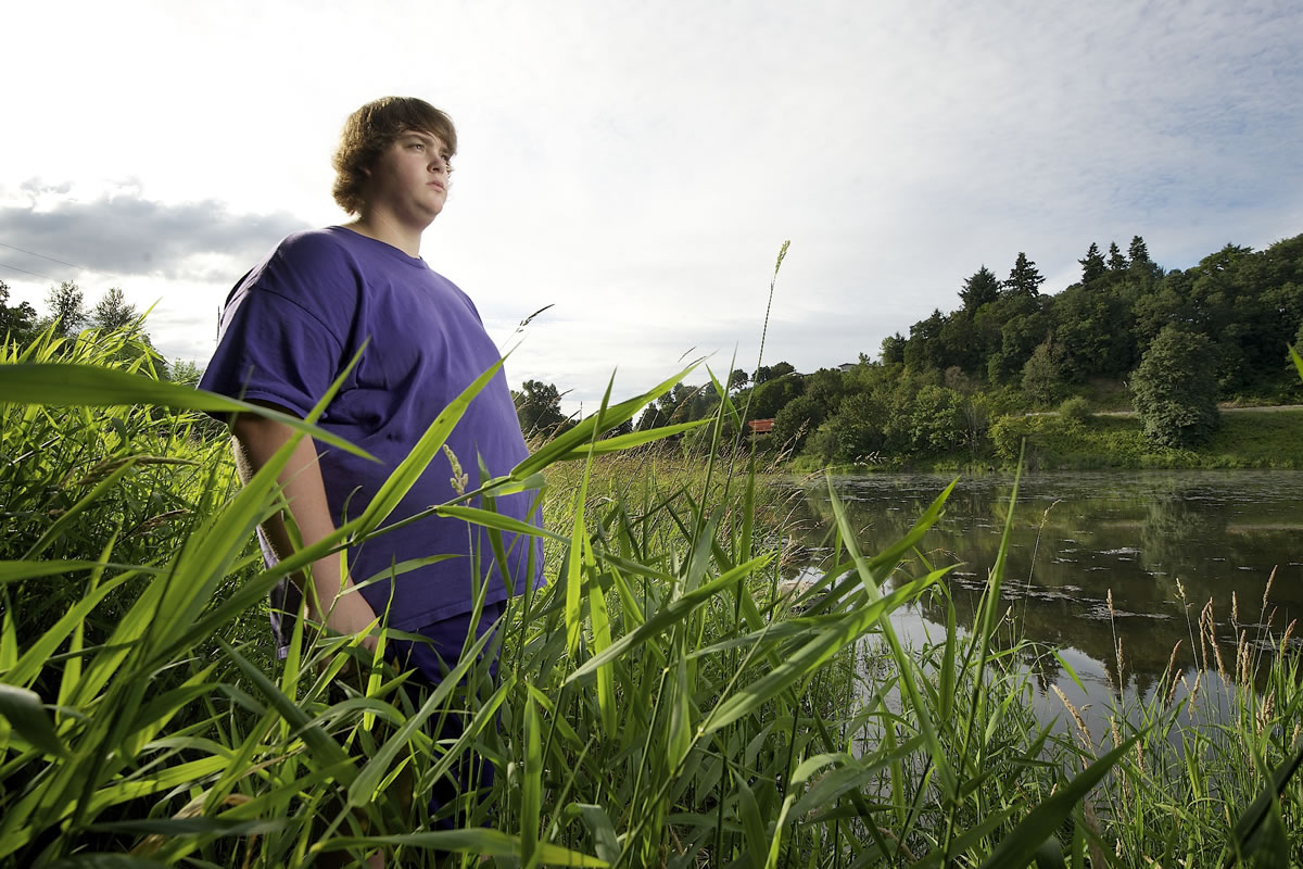 Taylor Olson, 17, stands beside Salmon Creek in Vancouver on Thursday.