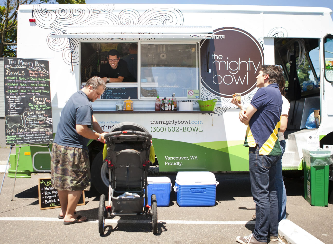 Customers gather at The Mighty Bowl, the first mobile food truck in Vancouver, at the intersection of East 22nd and Main streets at lunch on Wednesday.