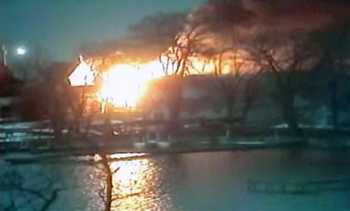 This image taken from video shows a wide view of homes on fire in Webster, N.Y., where a gunman ambushed four volunteer firefighters responding to an intense pre-dawn house fire early today.