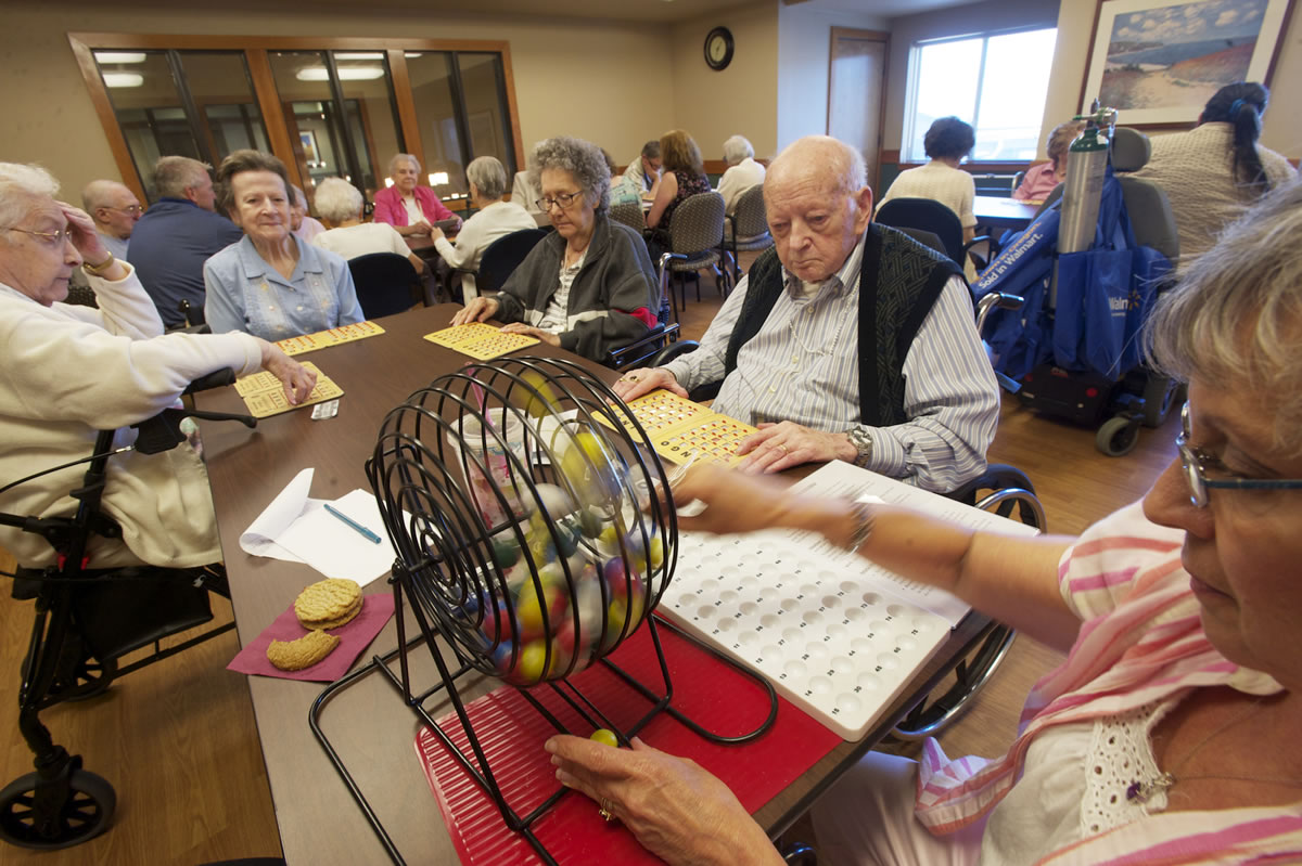 Volunteer Anita Krivitzky calls bingo for residents and visitors at The Quarry Senior Living, a 223-unit assisted- and independent-living community in east Vancouver that is undergoing an expansion.