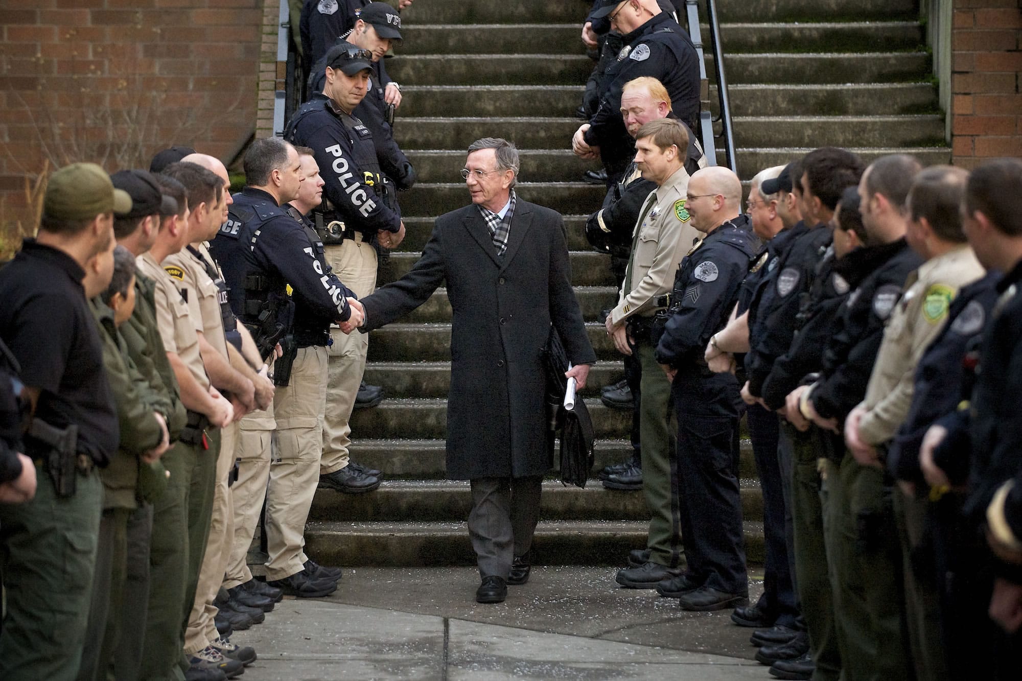 Officers from the Vancouver Police Department and Clark County Sheriff's Office line the stairs and walkway outside the Clark County Courthouse Friday afternoon to give Judge John Wulle a surprise send-off on his last day presiding as judge.