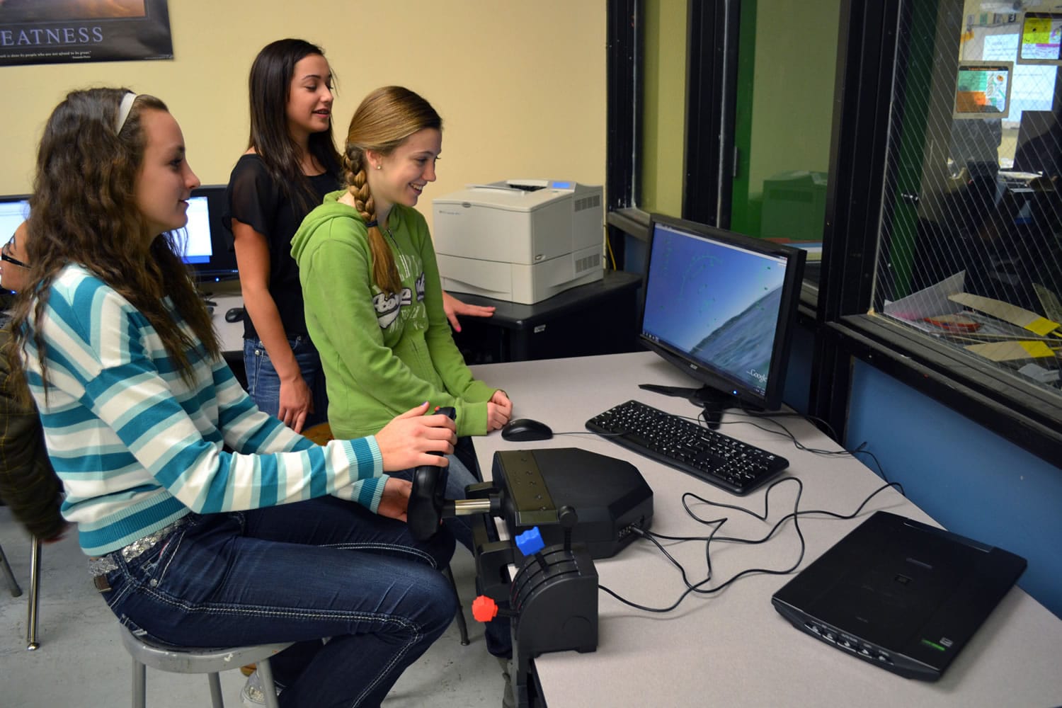 Ridgefield: View Ridge Middle School eighth graders Taryn Ries, from left, Makayla Draper and Rosaline Mayfield use a flight simulator purchased with $500 in grant funding from the Ridgefield Public Schools Foundation.