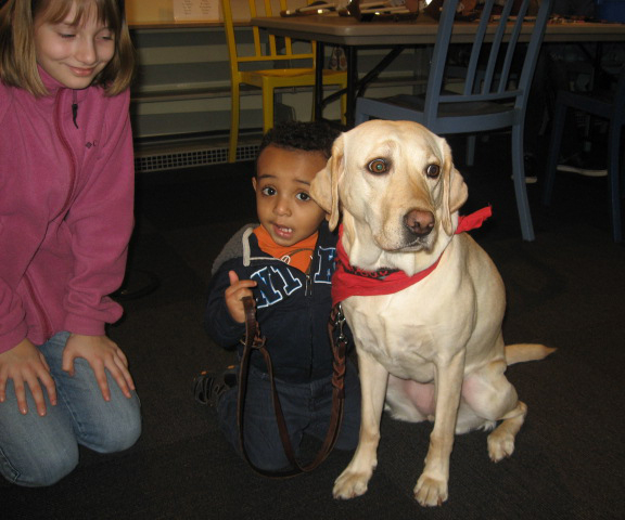 Esther Short: Emma Ellard, left, lets a young boy greet her dog, Luna, during the &quot;Read to a Guide Dog Puppy&quot; event held Jan. 12 at the Vancouver Community Library.