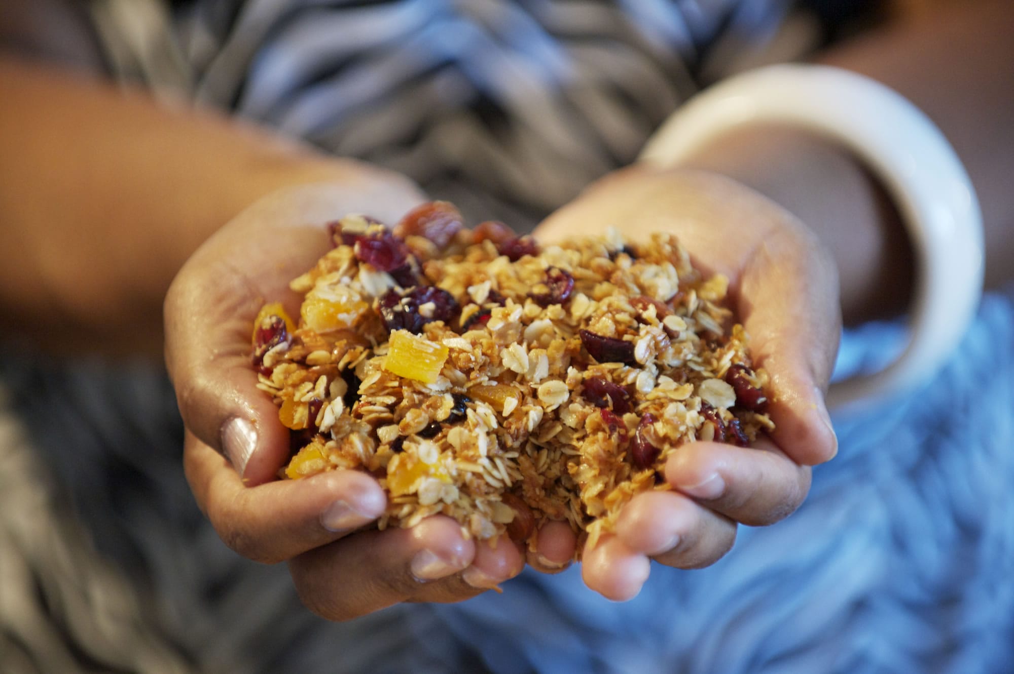 Vancouver resident and cookbook author Chrisetta Mosley scoops up a handful of homemade fruit and nut granola.