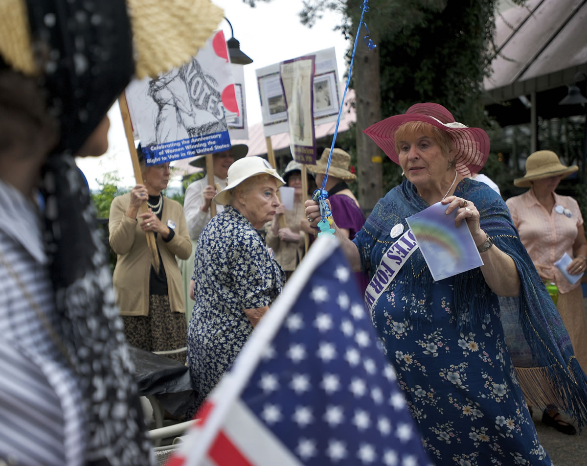 A group associated with the Democratic Women's Club of Clark County gathers outside the Red Lion Hotel at the Quay on Monday before walking along the Columbia River Waterfront to celebrate the 19th Amendment.