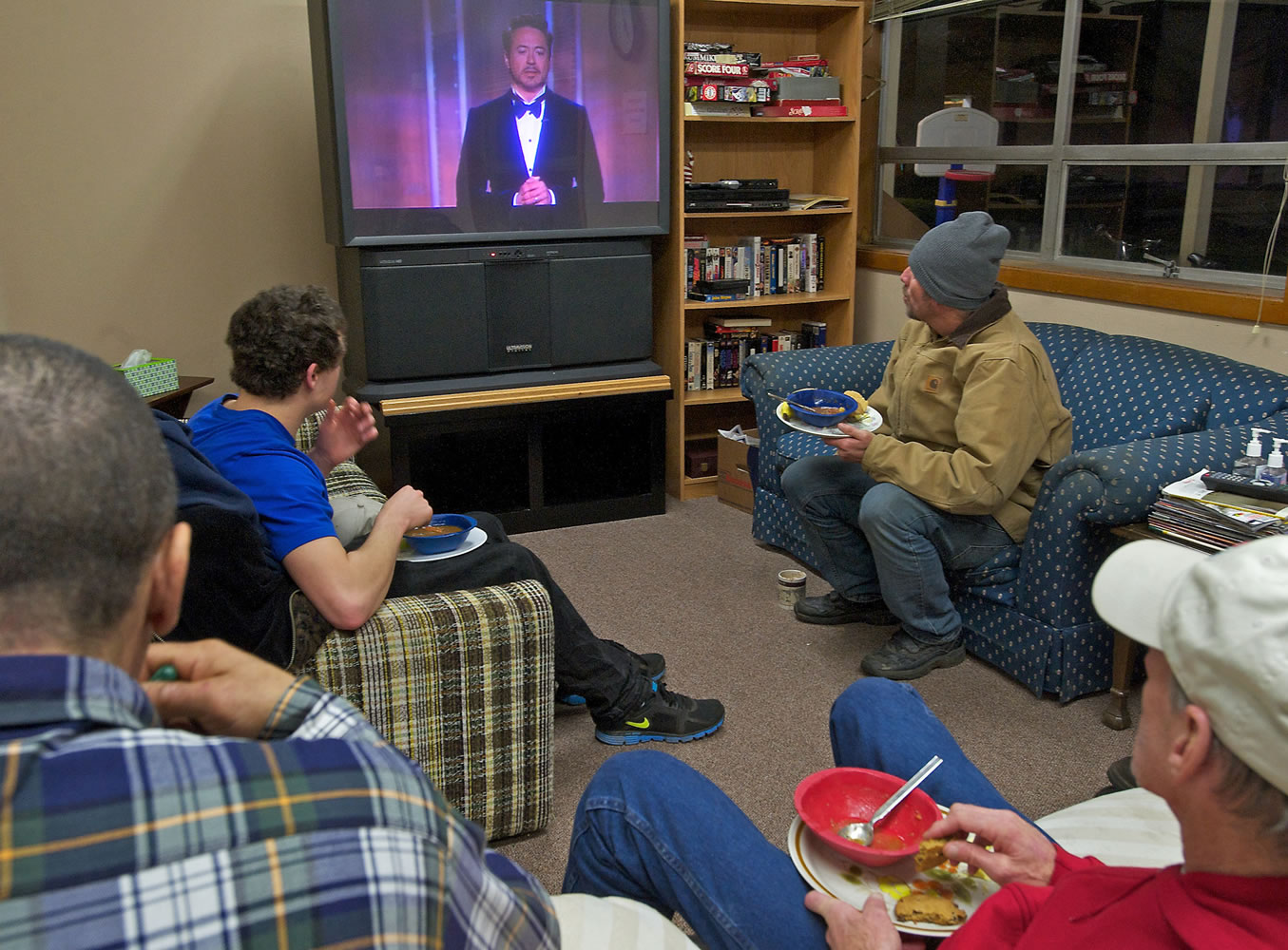 Men watch the Golden Globe awards Sunday on a donated television at St. Paul Lutheran Church.