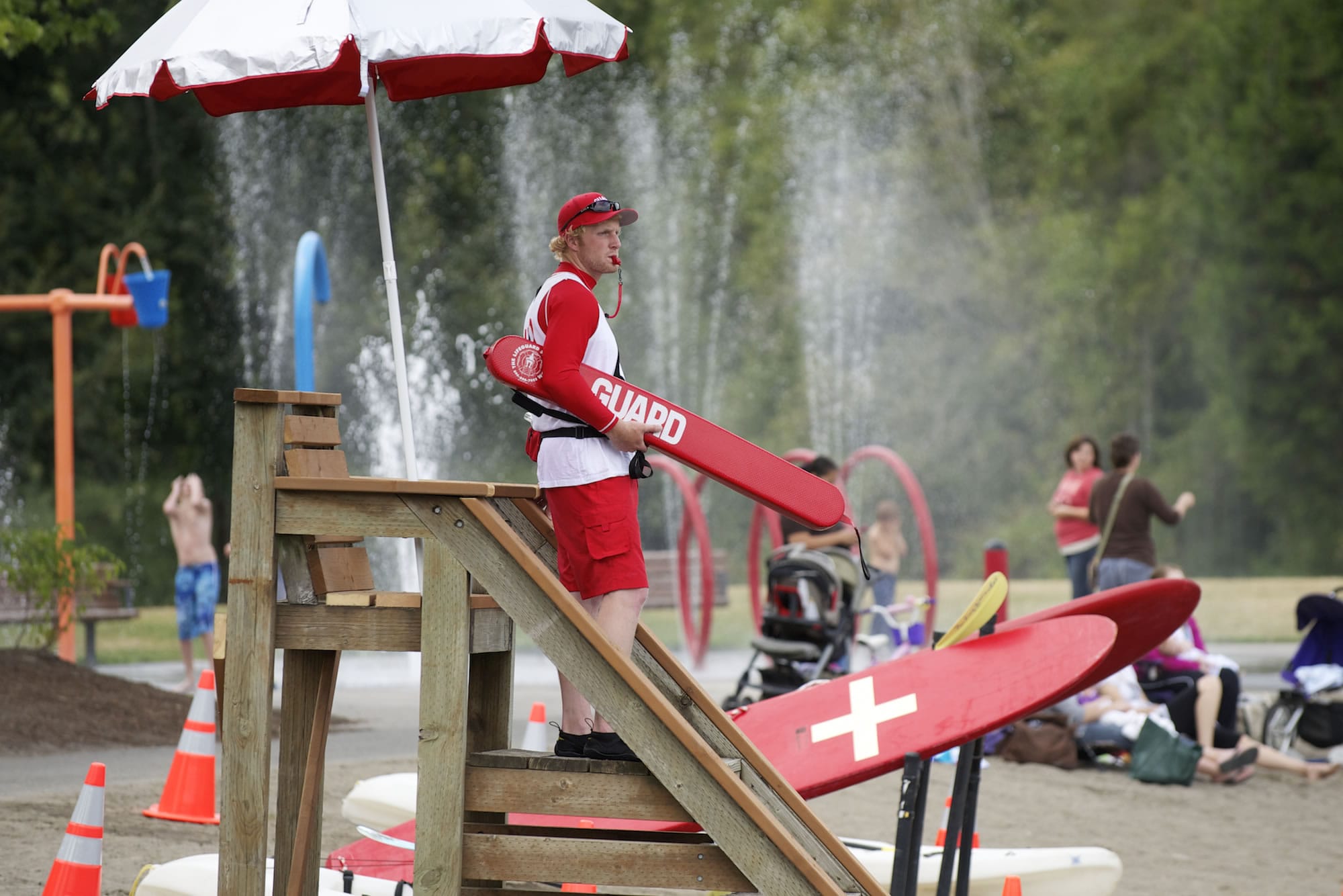 Photos by Steven Lane/The Columbian
Lifeguard Trevor Carnahan, 22, watches over swimmers at Salmon Creek Regional Park. Lifeguards returned to the park's Klineline Pond on Wednesday for the first time since 2010.