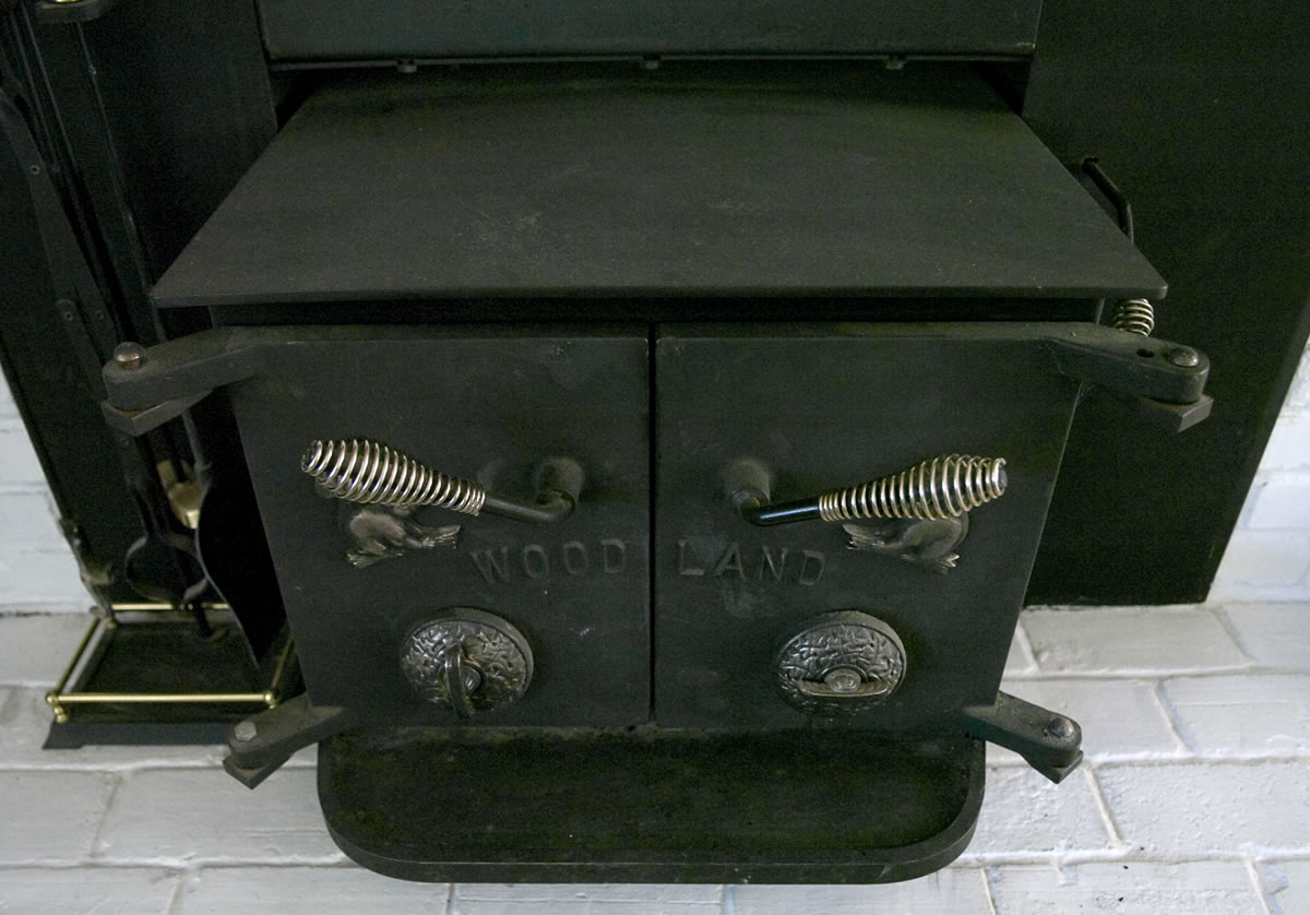 An old wood stove insert sits inside the Ogden neighborhood home of Nancy McNatt in 2008.