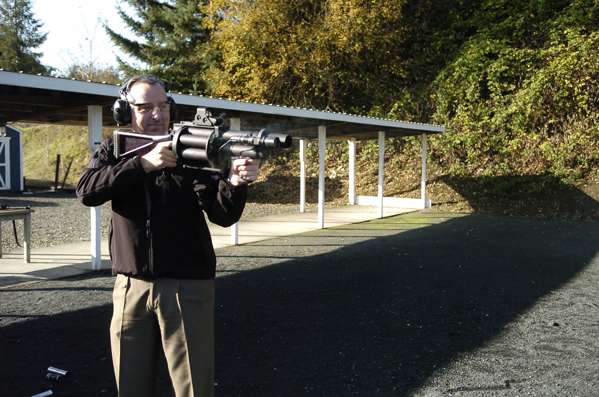 Clark County Sheriff's detective Todd Barsness demonstrates firing a 'less-lethal' weapon at the sheriff's firing range earlier this year.