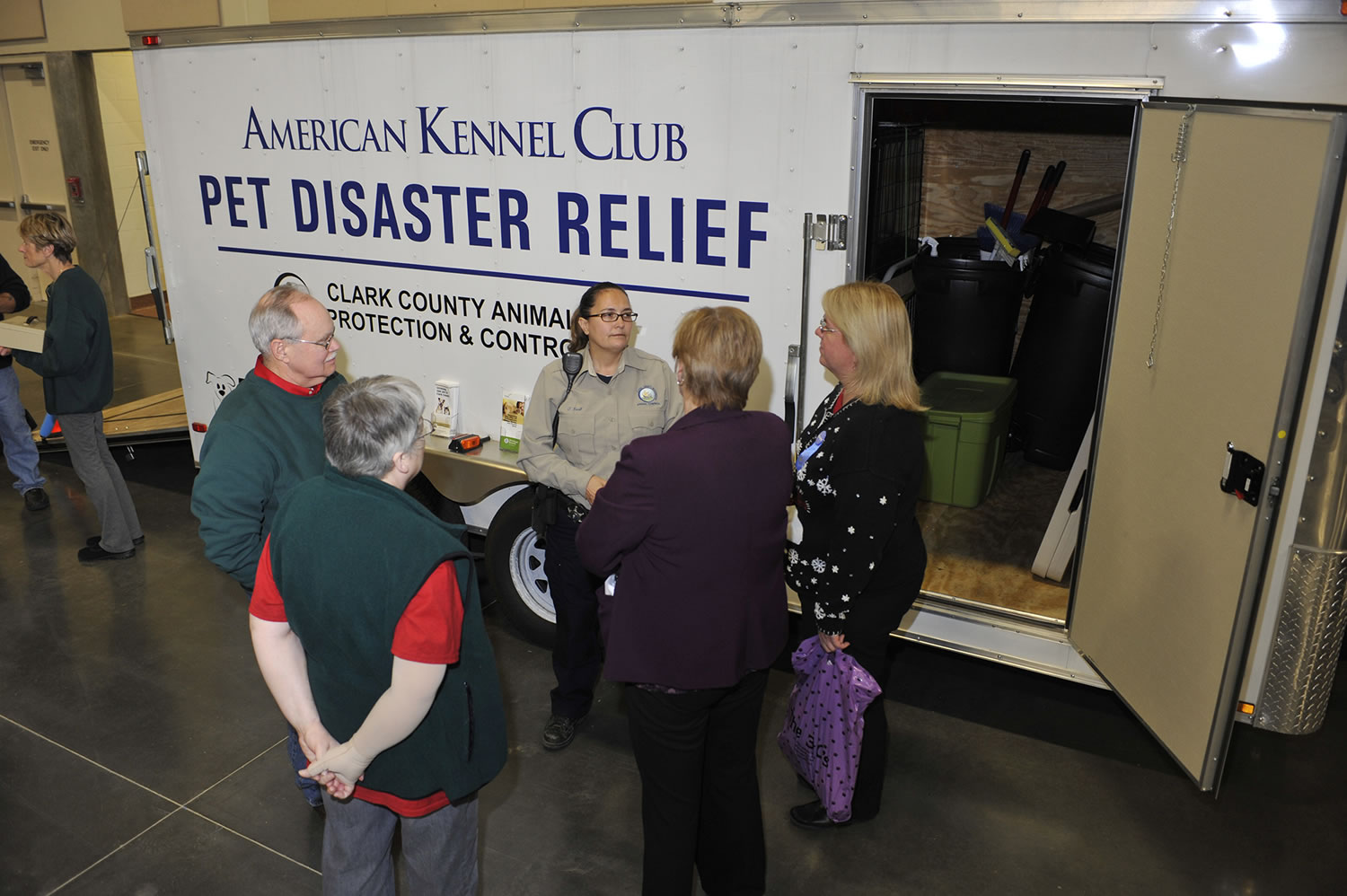 Visitors to the Greater Clark County Kennel Club&#039;s dog show last weekend chat at the unveiling of Clark County&#039;s pet disaster relief trailer at the Clark County Event Center at the Fairgrounds in Ridgefield. The 16-foot trailer can house 65 animals in an emergency.