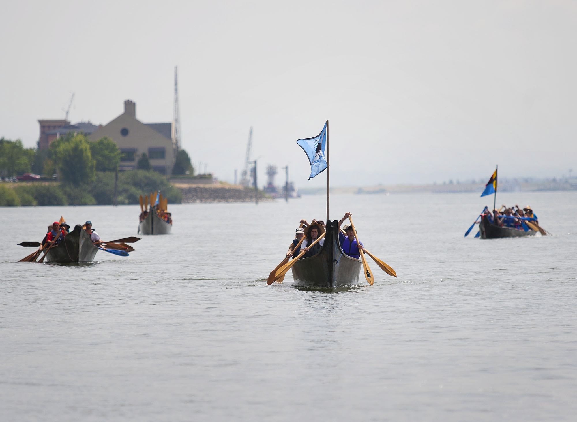Canoes from the Cowlitz, Warm Springs, Snohomish, Clatsop-Nehalem and Snoqualmie tribes approach the welcoming party Tuesday on the Columbia River just east of Who Song &amp; Larry's.