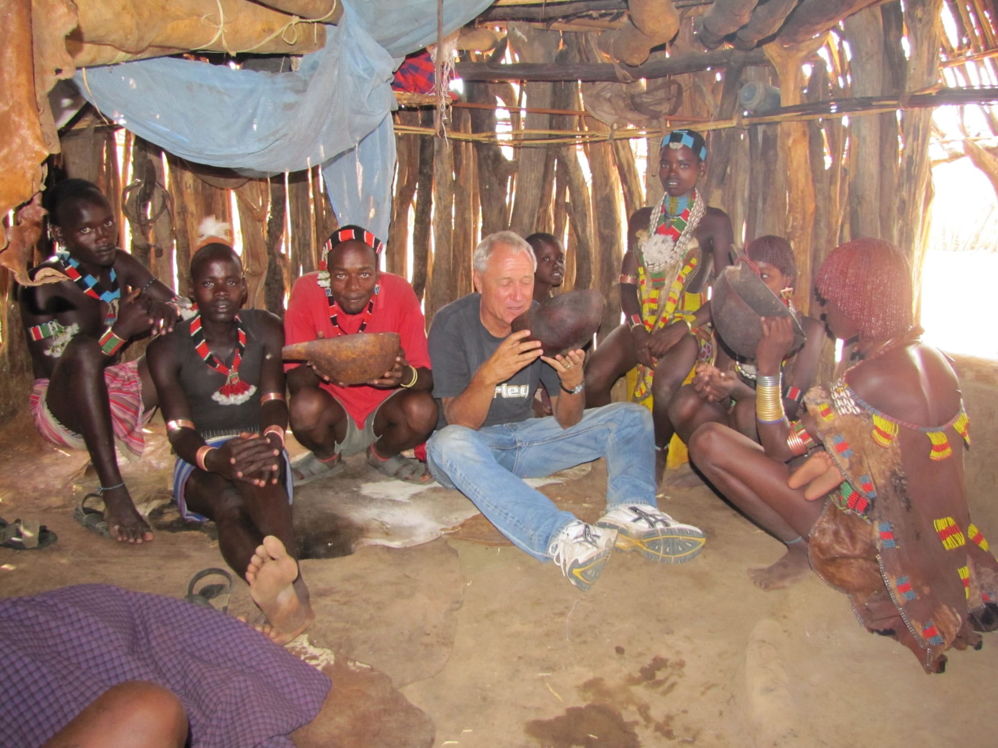 Washington State University Vancouver instructor Barry Hewlett enjoys refreshment with some nomadic people of southwest Ethiopia.