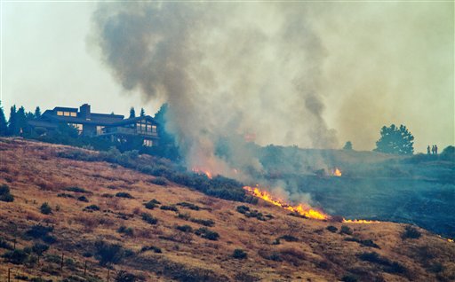 Flames approach a house near Westview Drive in Wenatchee, Wash., about 140 miles east of Seattle, early Tuesday morning, Sept. 11, 2012. About 180 homes in Wenatchee were evacuated Sunday, Sept. 9.