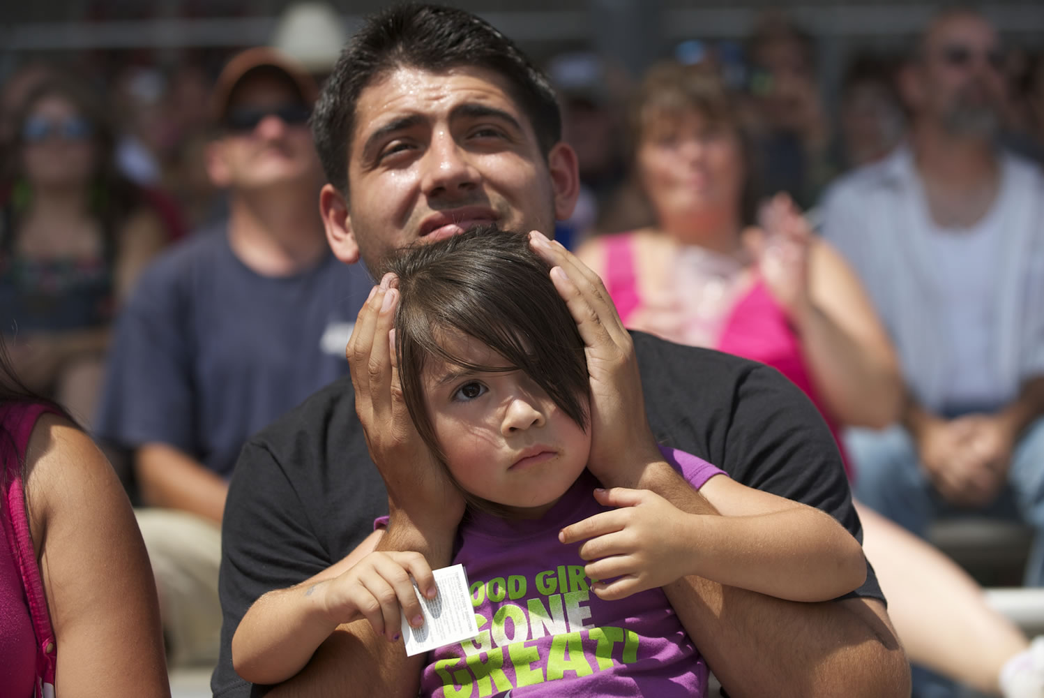 Adam and Sarah Cardona of Salem, Ore., watch the afternoon Monster Truck Show at the fair.