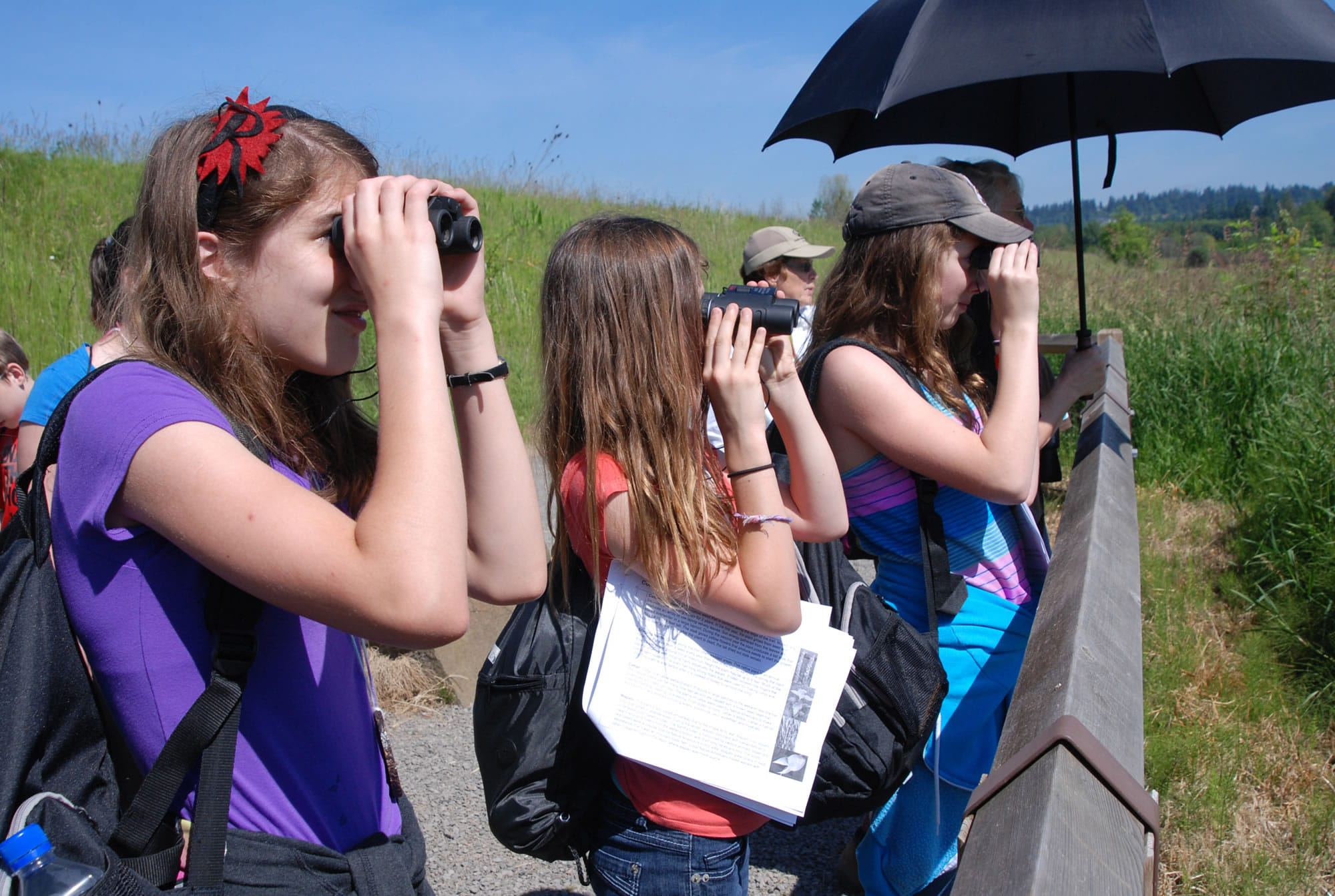Washougal: Canyon Creek Middle School sixth-graders Rachel McDonald, from left, Allie DuBose and Audrey Hinchliff get a closer look at nature with binoculars during outdoor school, held June 6 and 7 at Steigerwald Lake National Wildlife Refuge and Beacon Rock State Park.