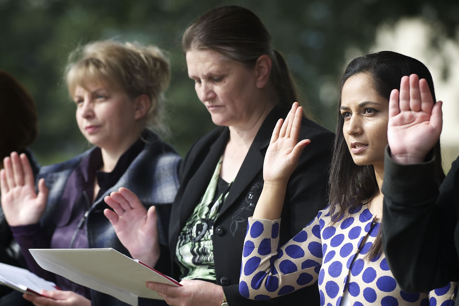 Sindhu Koirala, right, of Nepal recites the Oath of Allegiance during a U.S. Citizenship and Immigration Services naturalization ceremony Friday at the Fort Vancouver National Historic Site. She was among 29 people to become new U.S.