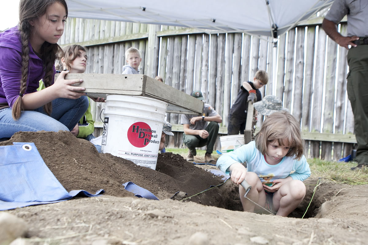 Photos by Vivian Johnson for The Columbian
Maddie Heckert, 7, digs as Teyline McLean sifts dirt in a mock archaeology exercise at Fort Vancouver.