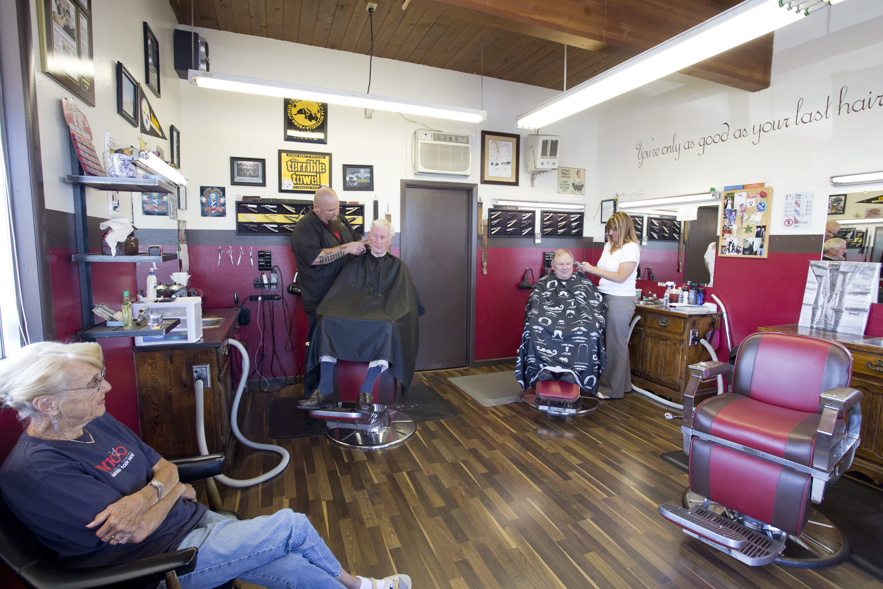 Barber &quot;Big Rick&quot; Conn, left, and owner Rochelle Debuse tend to customers Wednesday at Bernie &amp; Rollies Barber Shop, which will close after Saturday's 8 a.m. to 3 p.m. shift and reopen Tuesday at 10304 Southeast Mill Plain Boulevard.