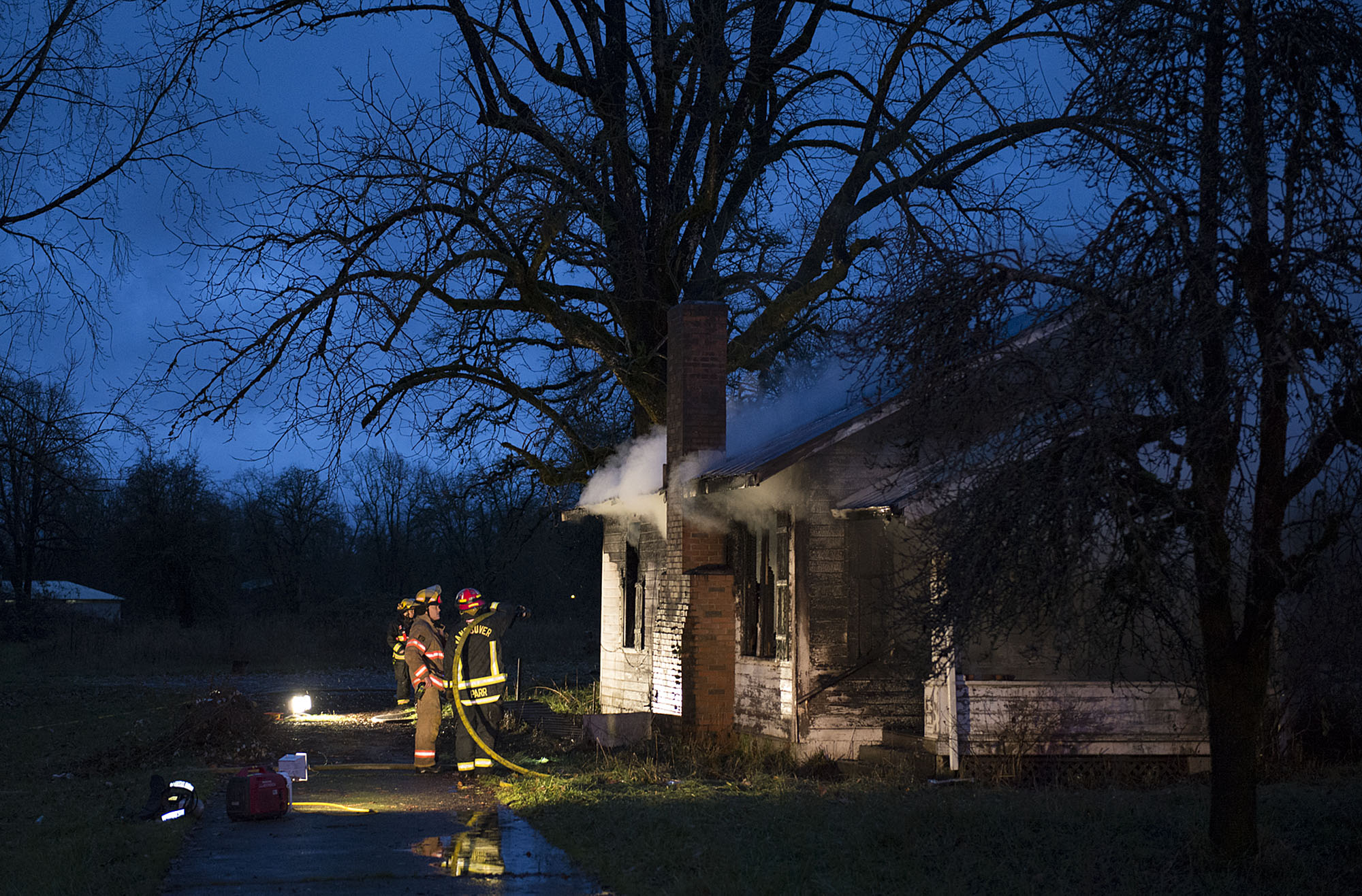 Firefighters respond at the scene of a structure fire Friday morning, Dec. 4, 2015 at 18014 N.E. Fourth Plain Boulevard.