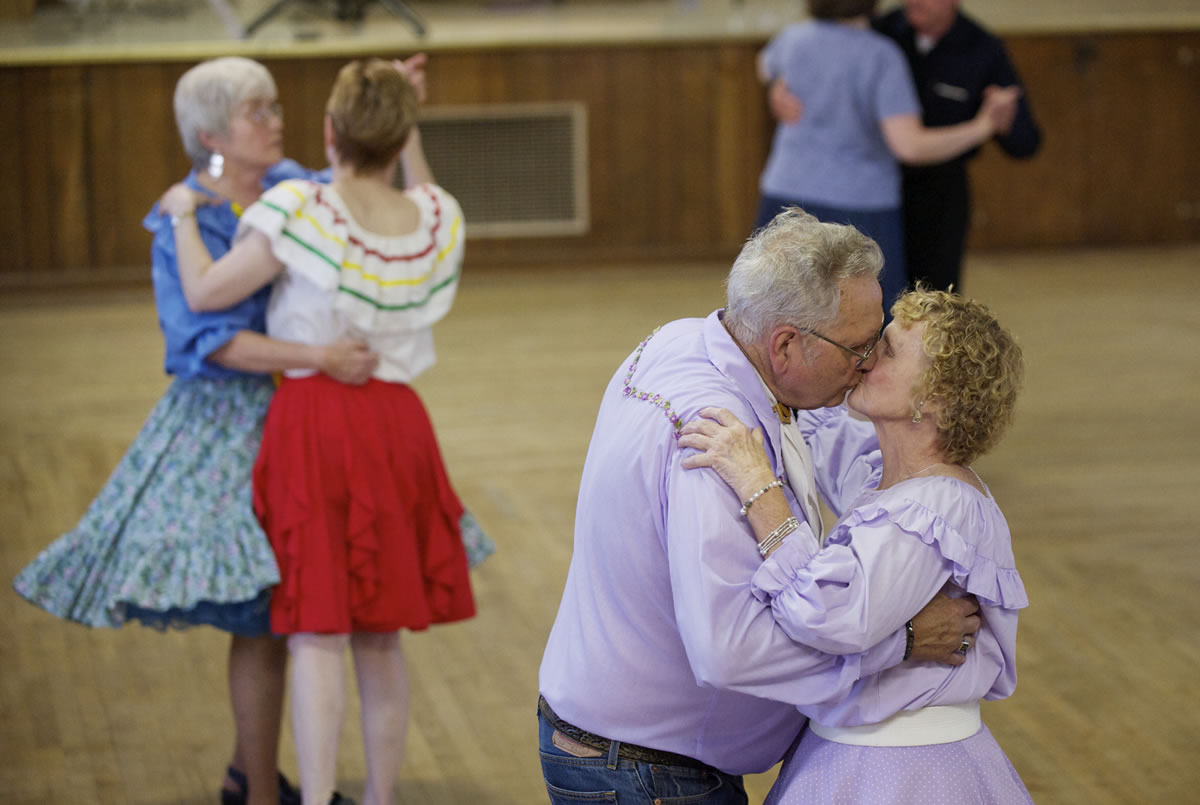 Elmer Toops kisses his wife, Betty, at the Hazel Dell Grange Hall recently.