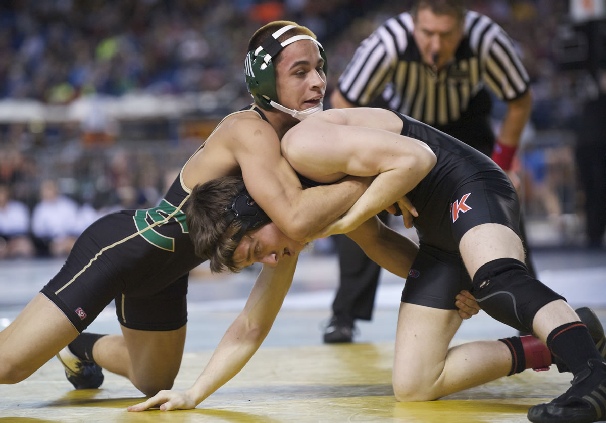 Evergreen's Ramon Ortiz, left, beats Warren Sprecher from Central Kitsap in the 120-pound weight class quarterfinals of the 4A State Wrestling Tournament in Tacoma, Friday, February 15, 2013.