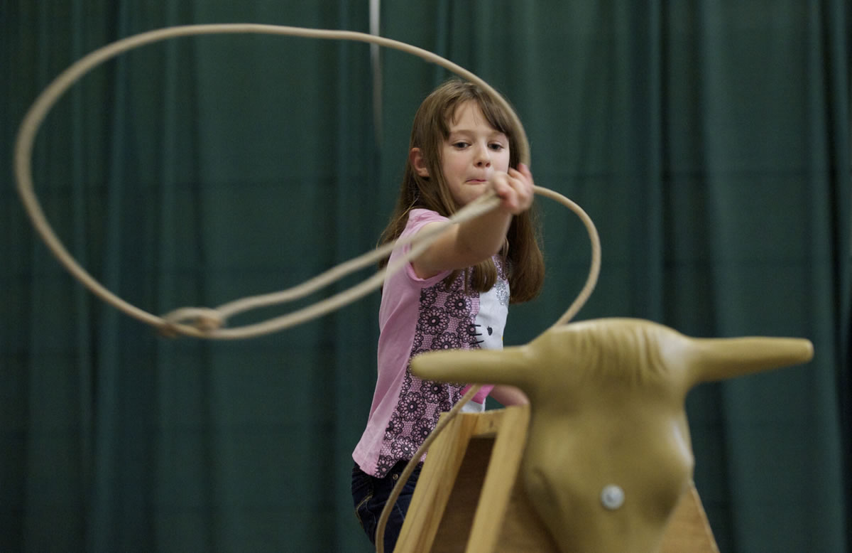 Kaylee Woods, 8, of Clackamas practices her roping skills at the Washington State Horse Expo at the Clark County Event Center at the Fairgrounds on Sunday.
