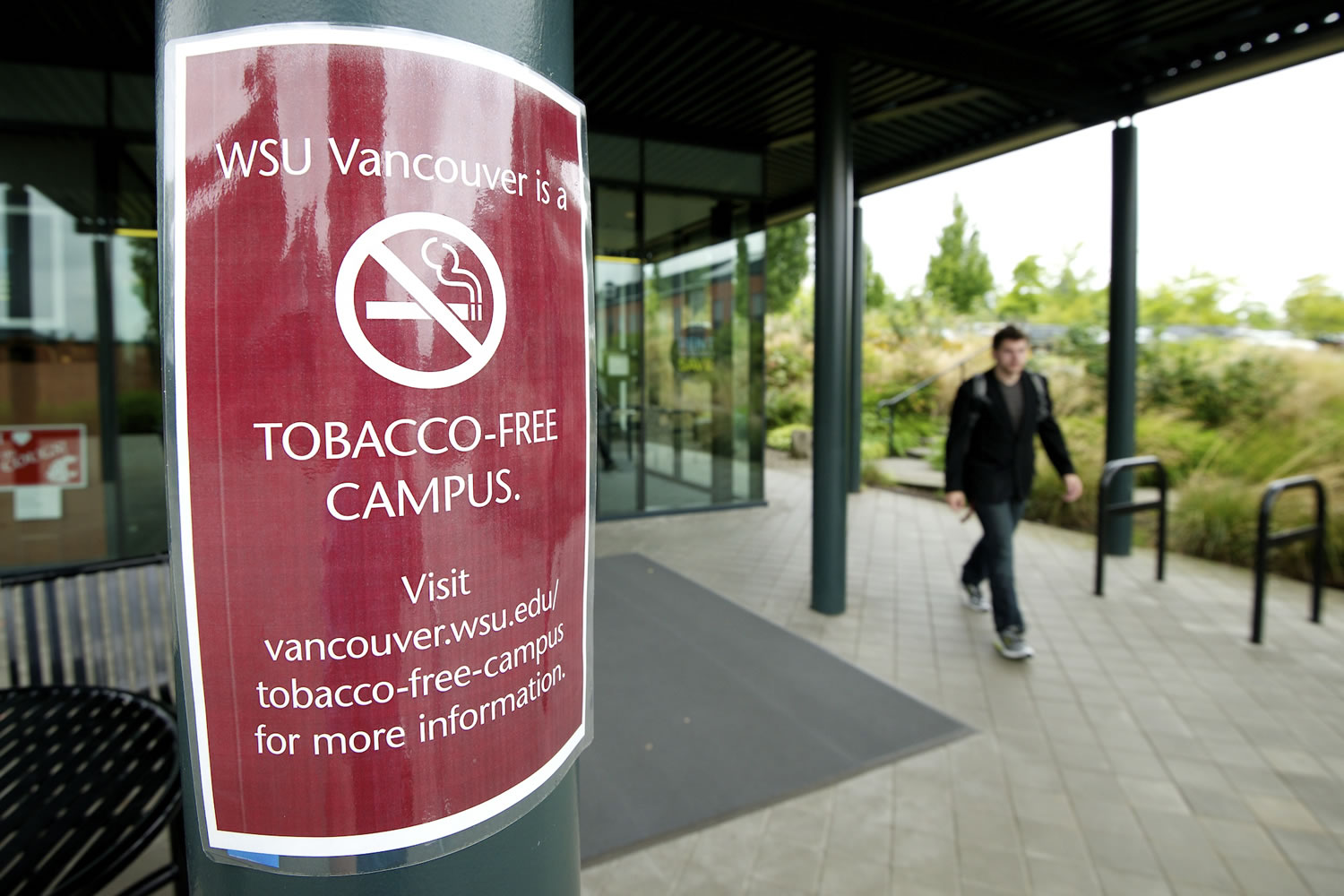 A student walks past a temporary sign Wednesday on the Washington State University Vancouver campus.