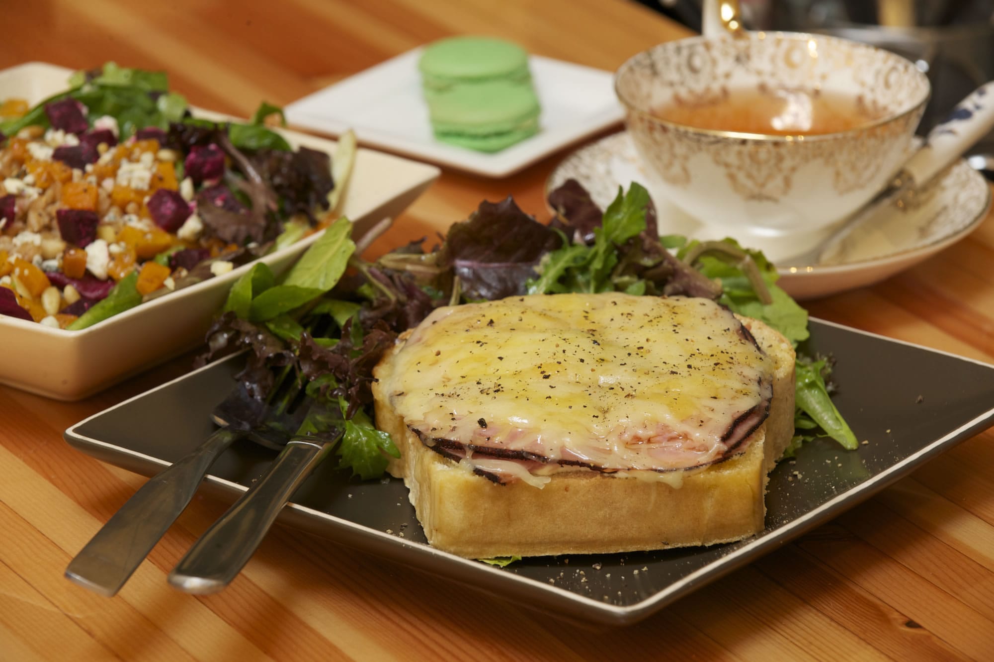 A Croque Monsieur sandwich with beet, butternut squash, gorgonzola and pine nut salad, tea and pistachio macaron is served at C'est la vie.
