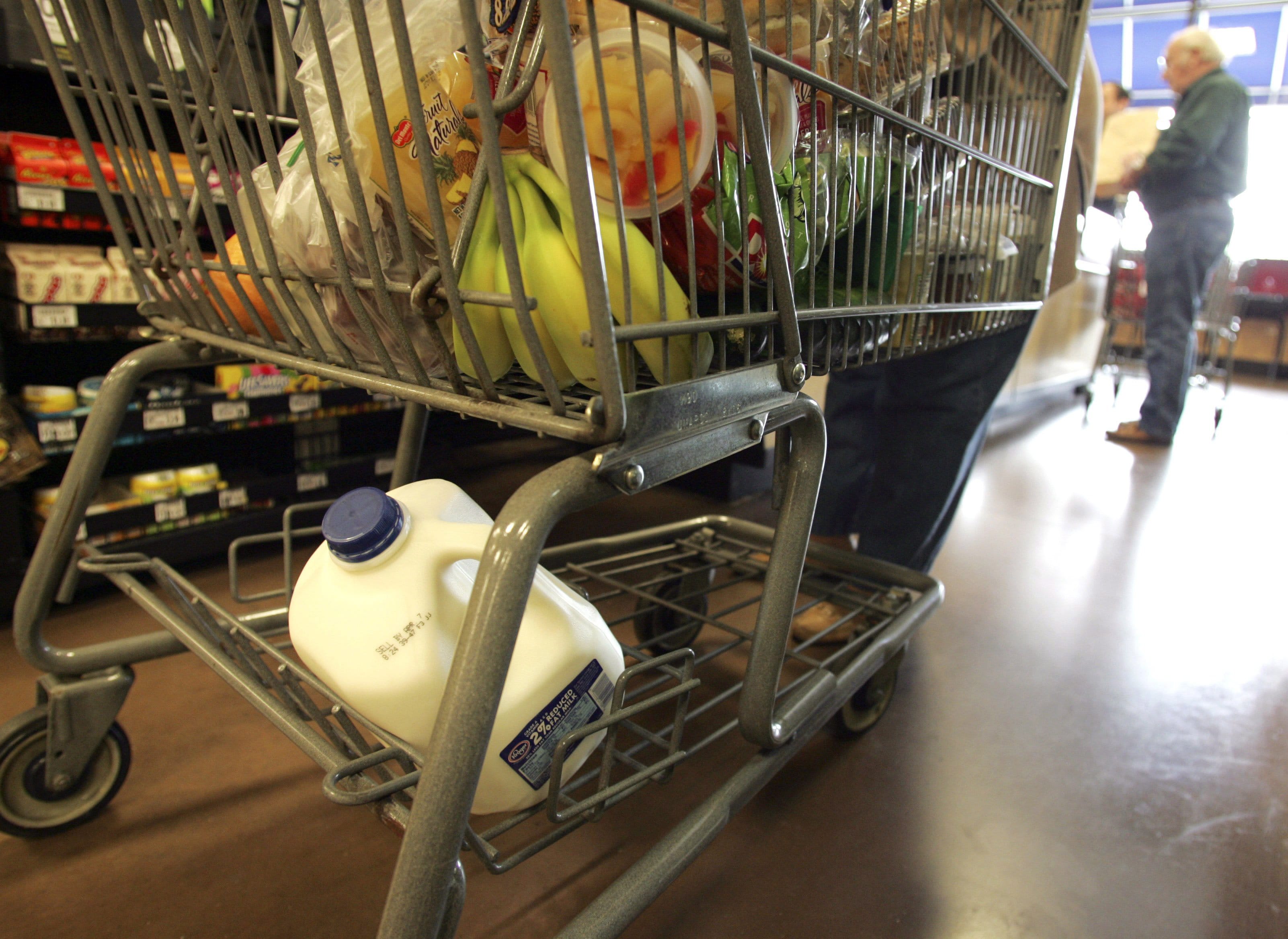 A cart full of a groceries sits at a check-out counter at a Kroger store in Gahanna, Ohio.