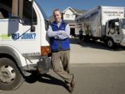 Ben Hoskins, local franchise owner of 1-800-GOT-JUNK and You Move Me, stands outside a customer's home.