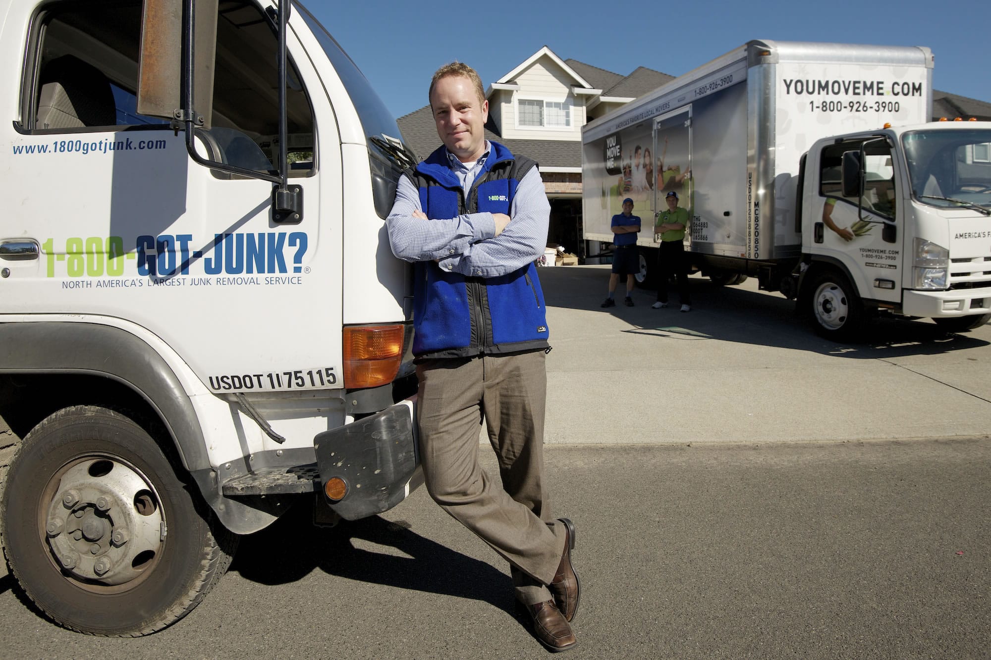 Ben Hoskins, local franchise owner of 1-800-GOT-JUNK and You Move Me, stands outside a customer's home.
