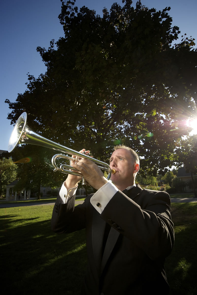 Main photo by Troy Wayrynen/The Columbian
Bruce B. Dunn, trumpeter and music educator with the Vancouver Symphony Orchestra, plays in Vancouver's Esther Short Park.