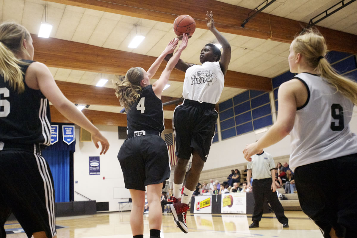 Mar'Shay Moore, from Fort Vancouver, shoots for two of her 11 points in Sunday's Les Schwab Roundball Shootout.