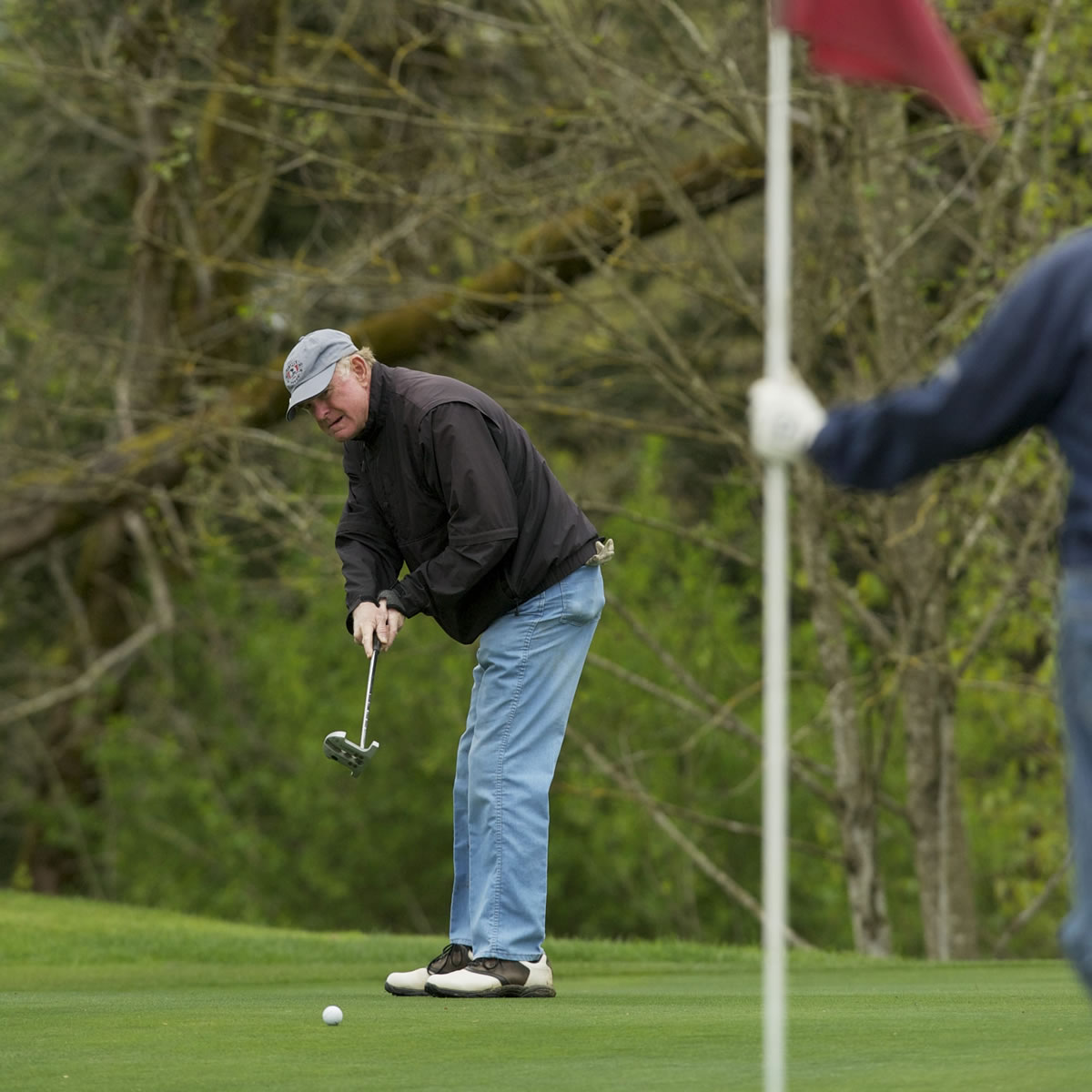 J.J Smith putts during a round of golf at Green Mountain Golf Course on April 12.