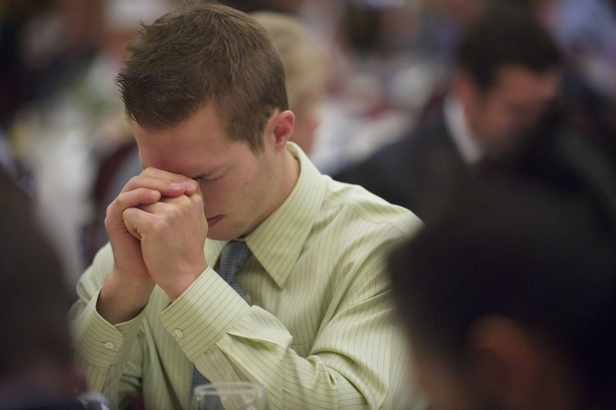 Jeff Miller, 23, of Washougal, prays during the Clark County Mayors' and Civic Leaders' 11th Annual Prayer Breakfast at the Hilton Vancouver Washington on Friday.