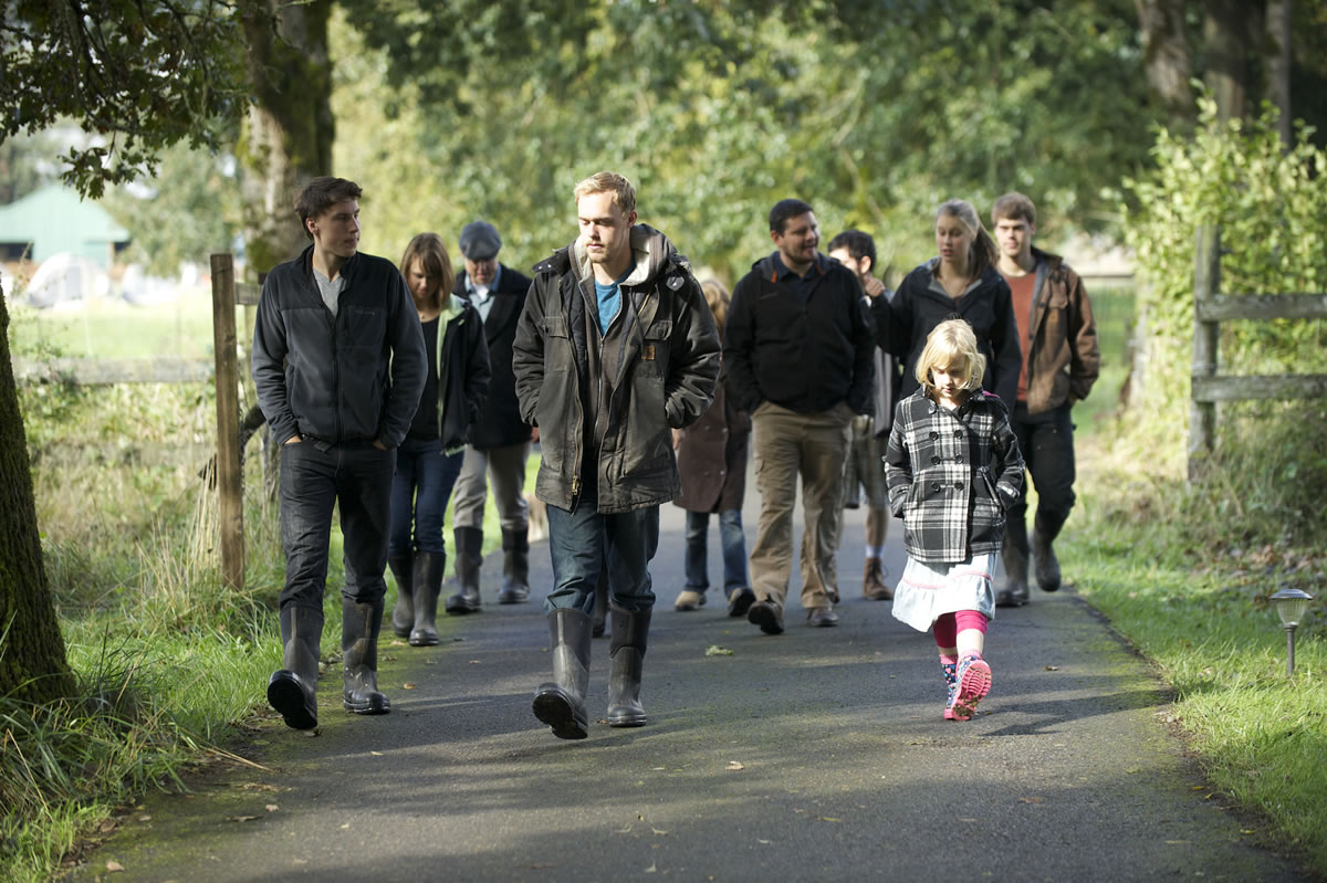 The Sturtevant Family walks along a path that winds through their 34-acre Botany Bay Farm on Oct. 3 in Brush Prairie.  The large family moved from Vancouver to the rural area in 2011 to start the farm and father Mark said everyone cheerfully chips in to help, even if there is a bit of griping at the early hours.