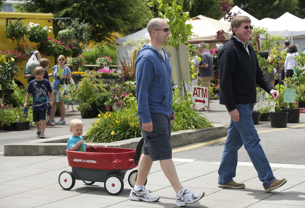 Jonathan Bippes, 30, of Vancouver pulls his son, Parker, 13 months, in a wagon Sunday as he celebrates Father's Day in step with his dad, Brian Bippes, 58, at the Vancouver Farmers Market.