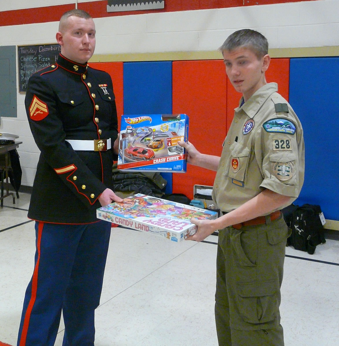 Walnut Grove: Christian Davison, senior patrol leader of Boy Scouts of America Troop 328, gives toys Dec. 17 to Cpl. Sean Houston. The toys were collected for the U.S.