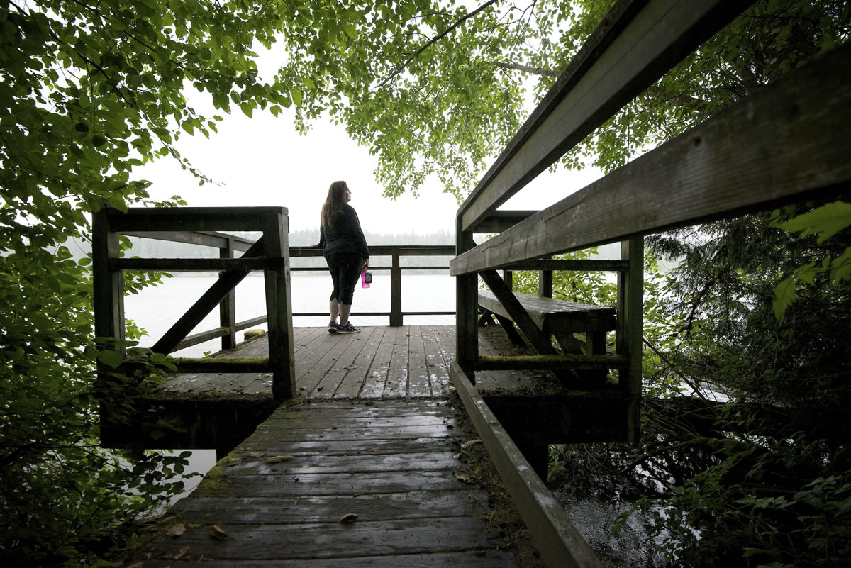 Laina Harris pauses during a walk on Heritage Trail to look out over Lacamas Lake in Camas on Wednesday.