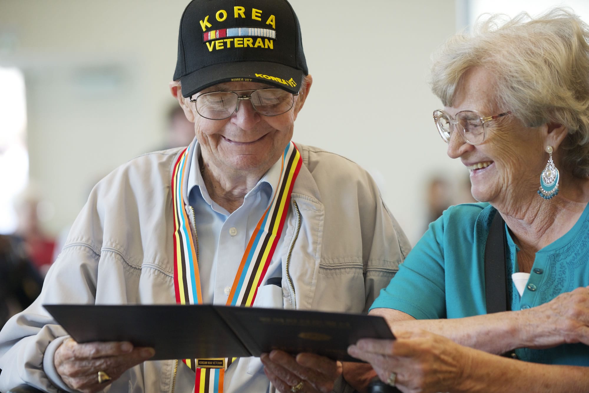 Korean War veteran Jimmie Olsen and wife of 64 years Jean Olsen, read a certificate from the South Korean government after receiving a medal at the Korean Liberation Day and Korean-U.S.
