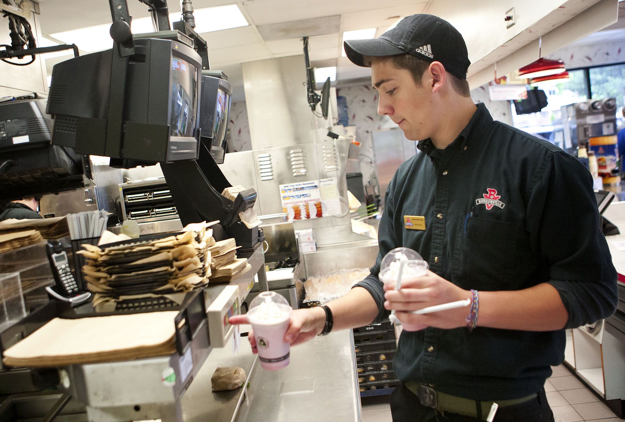 Lucas Schwartz, 17, clears an order before delivering shakes to customers as he works his shift at Burgerville on 2200 E. 4th Plain Mills Boulevard in Vancouver.