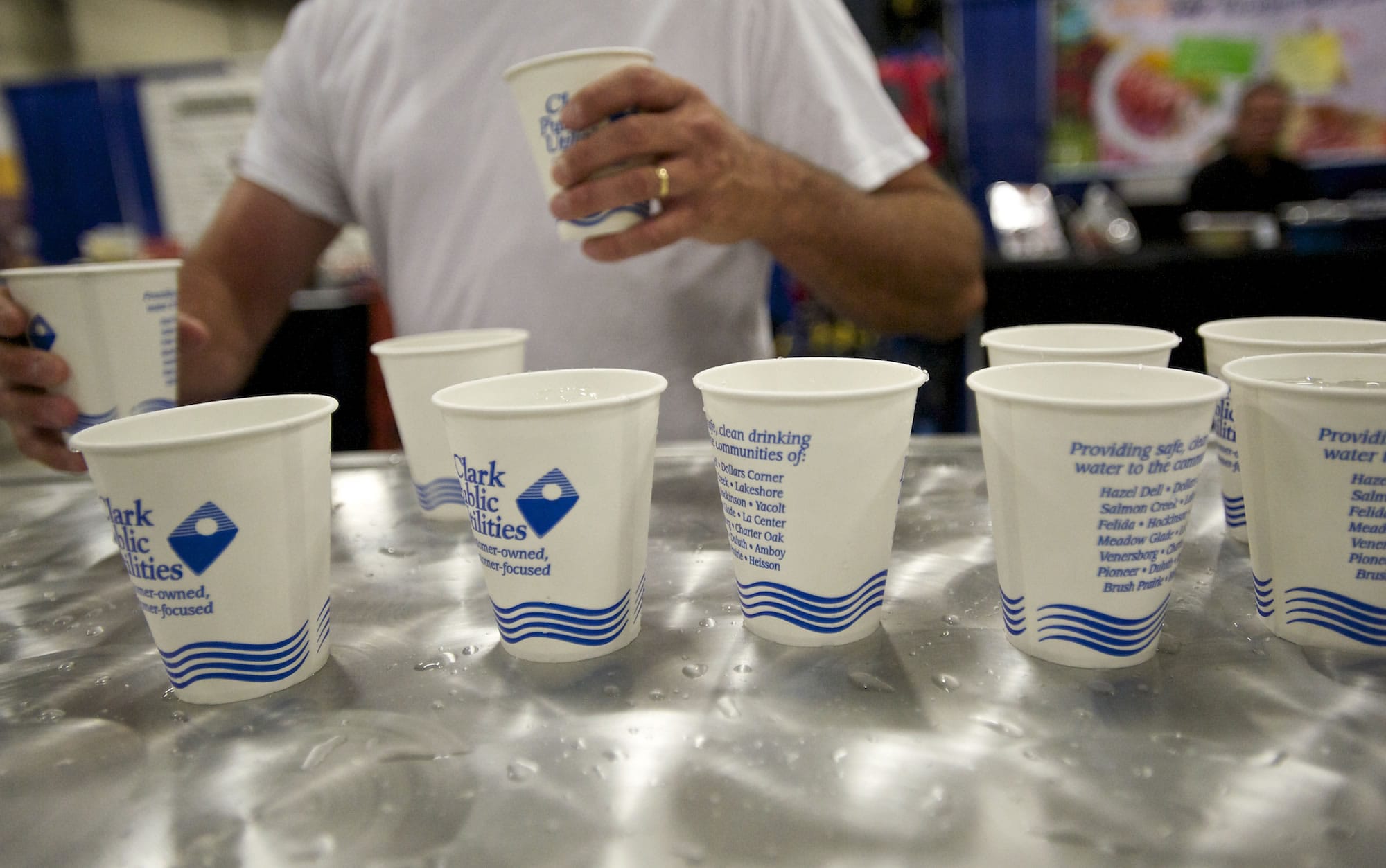 A fairgoer grabs ice water courtesy of Clark Public Utilities at the Clark County Fair on Monday.