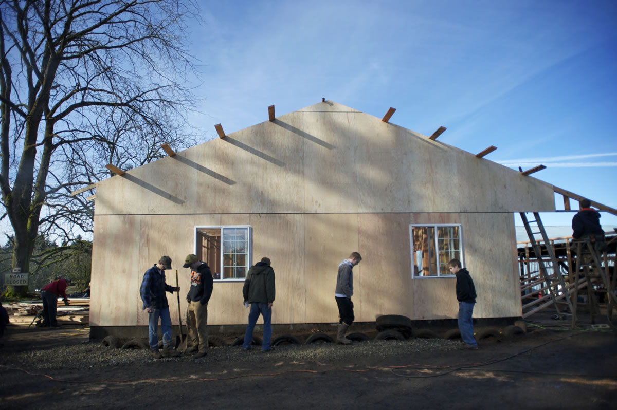 Volunteers help rebuild John Matson's barn on Saturday, which burned down earlier this year.