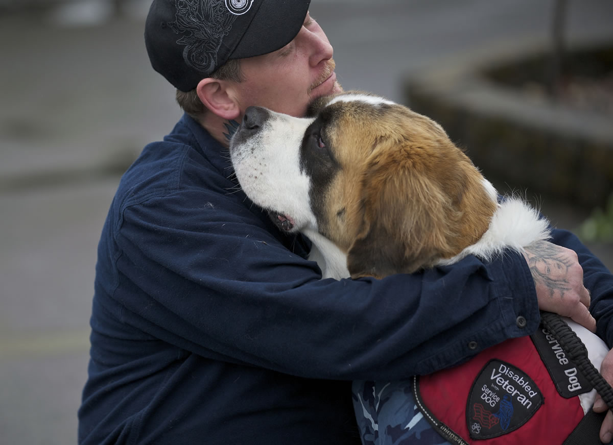 Desert Storm veteran Shawn Brooks, of Molalla, Ore., hugs his dog Bella before they test for a service-dog certification at Man's Best Friend kennel in Battle Ground.