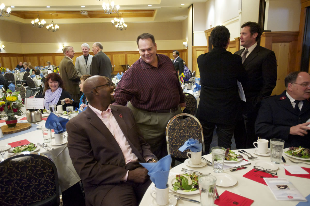 Former Portland Trail Blazer Jerome Kersey and radio announcer Brian Wheeler greet each other at The Salvation Army 2013 Annual Clark County Community Luncheon on Wednesday.