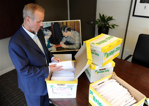 In this Tuesday, Oct., 16 photo, Portland attorney Kelly Clark examines some of the 14,500 pages of previously confidential documents created by the Boy Scouts of America concerning child sexual abuse within the organization, in preparation for releasing the documents Thursday, Oct. 18, in his office in Portland, Ore.