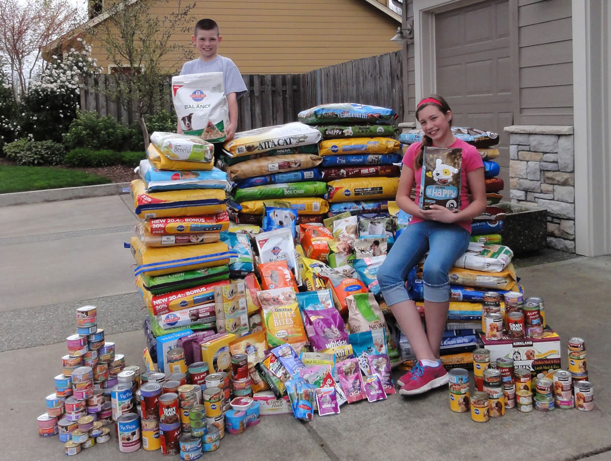 Felida: Fourth-grader Jared Wallingford and sixth-grader Alicia Wallingford show off pet food in April, which they helped gather during their recent donation drive.