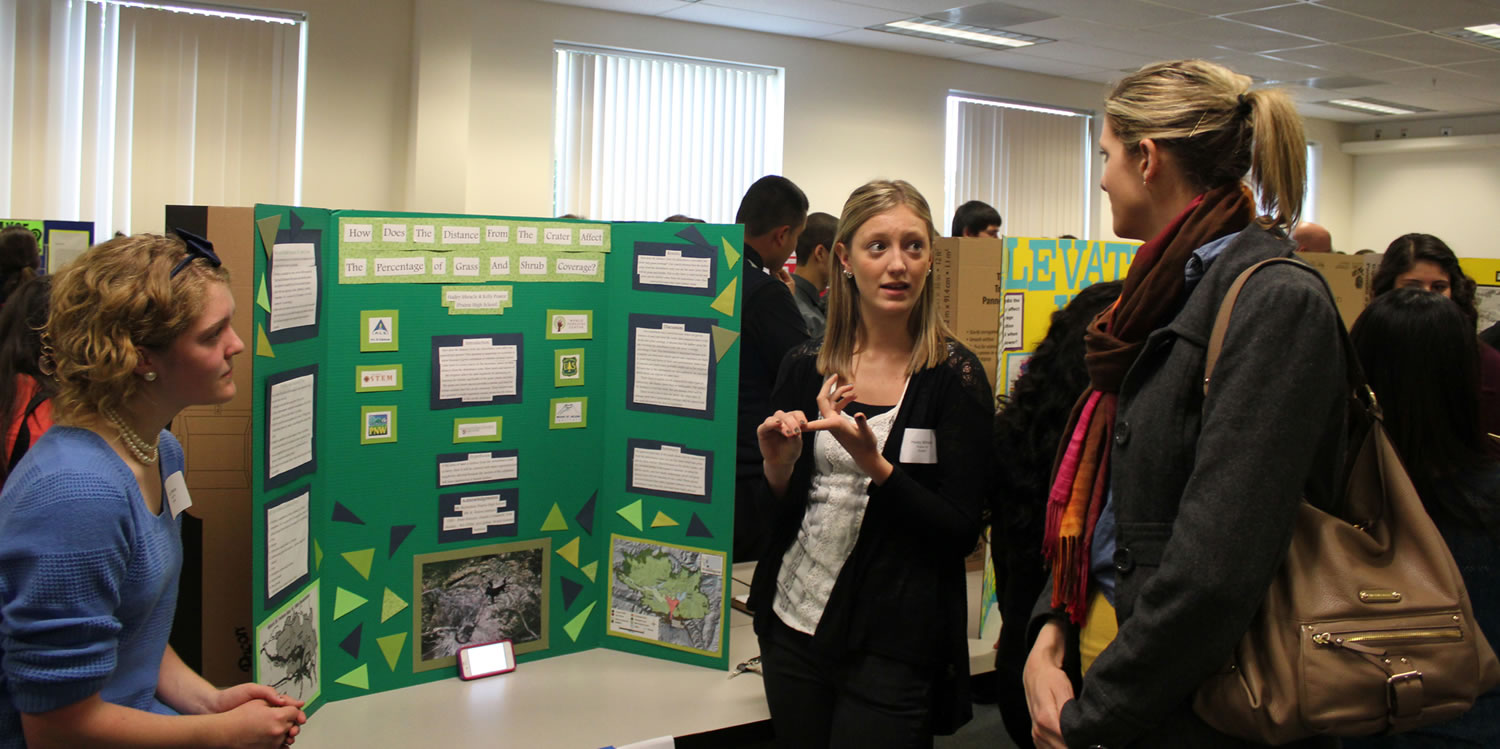 Salmon Creek: Prairie High School sophomores Kelly Pearce, left, and Hailey Miracle, center, present their research during the Mount St.