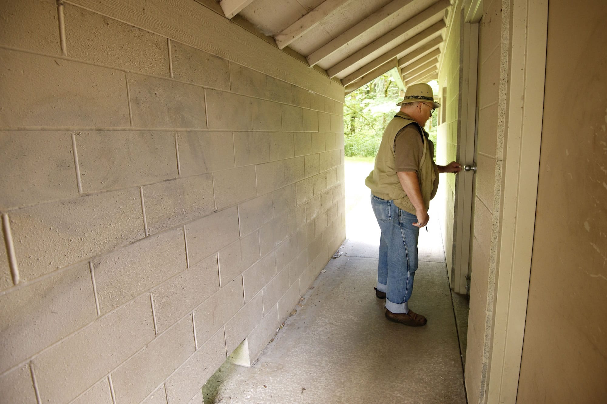 Hal Bauder, Clark County parks maintenance crew chief at Lewisville Park, examines a bathroom facility Thursday damaged by vandals.
